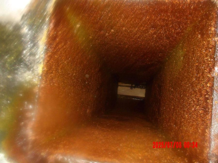 Grease-caked horizontal duct before cleaning by Oregon Hood Cleaning